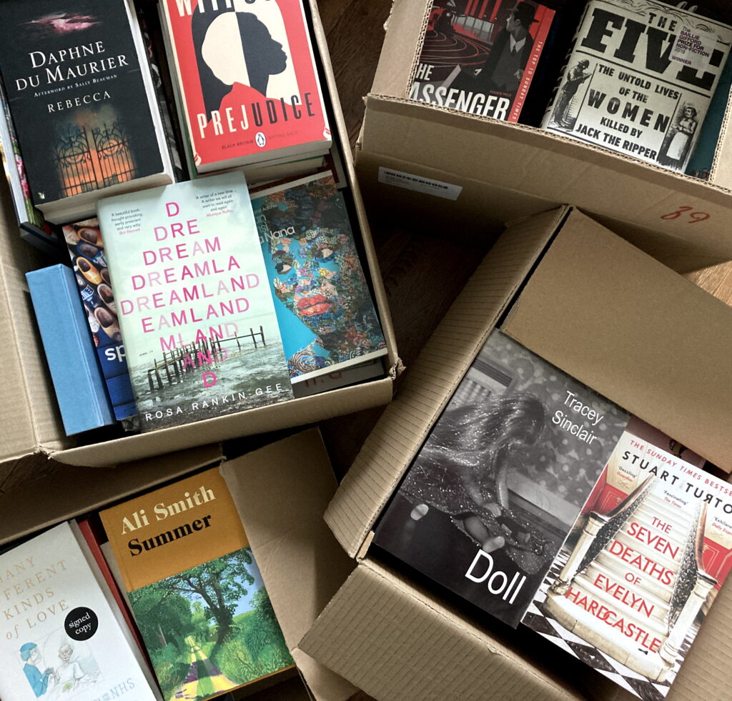 An image of several cardboard boxes full of books.