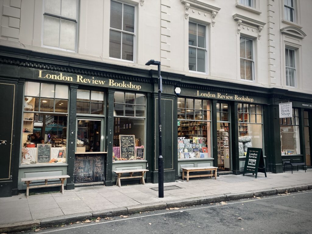 Exterior of the London Review Bookshop. The exterior of the shop is dark green, with 'London Review Bookshop' in gold letters above the windows.