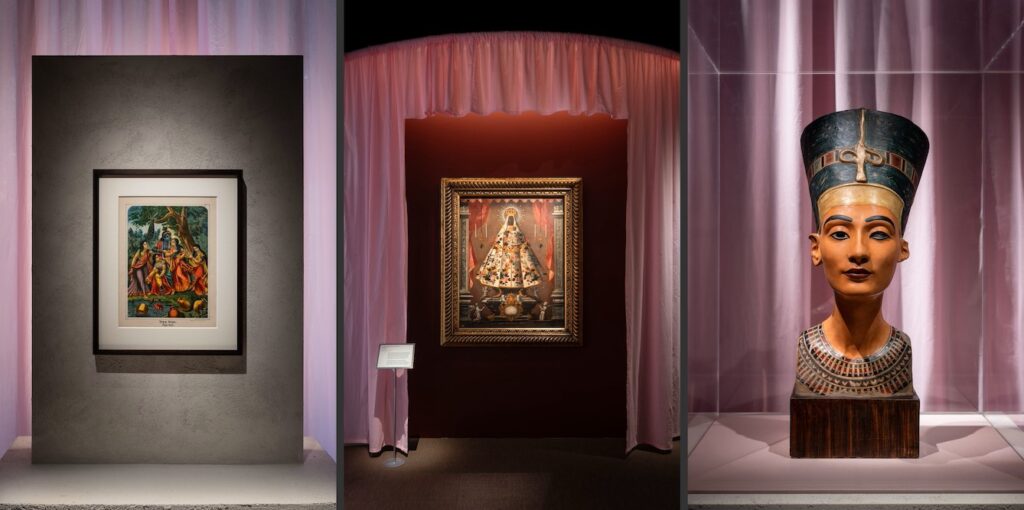 Photo of part of the exhibition collection showing. On the left hand side is a painting of Krishna with Radha and three gopis, 19th century, unknown maker.  In the middle, an image of the Virgin of Guadalupe, 1745 by an unknown maker, and on the right, a plaster copy of a bust of Nefertiti made in 1928 by Clarke and Davies.