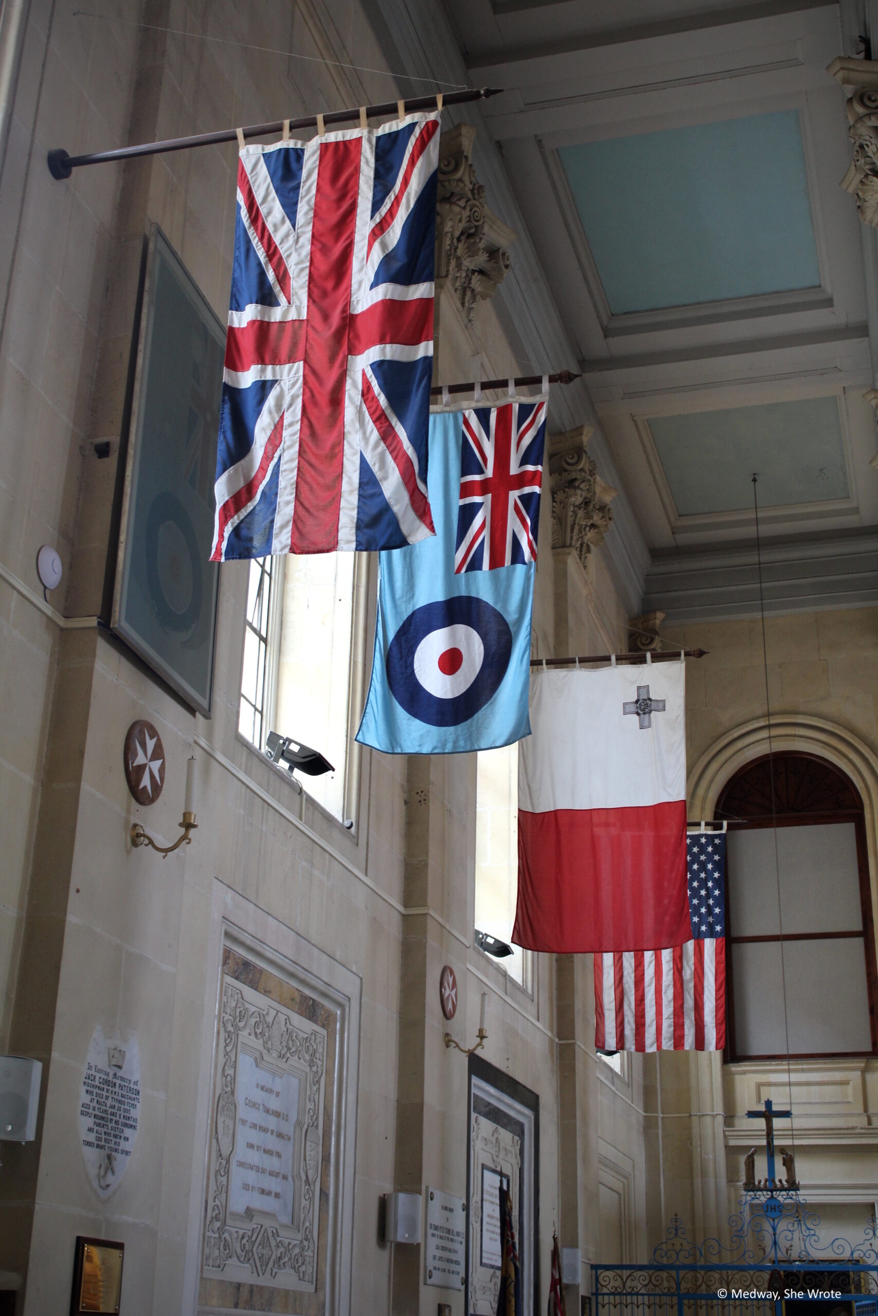Interior of St Paul's Pro-Cathedral, showing the flags of the UK, Royal Air Force, Malta and the USA hanging in the cathedral.