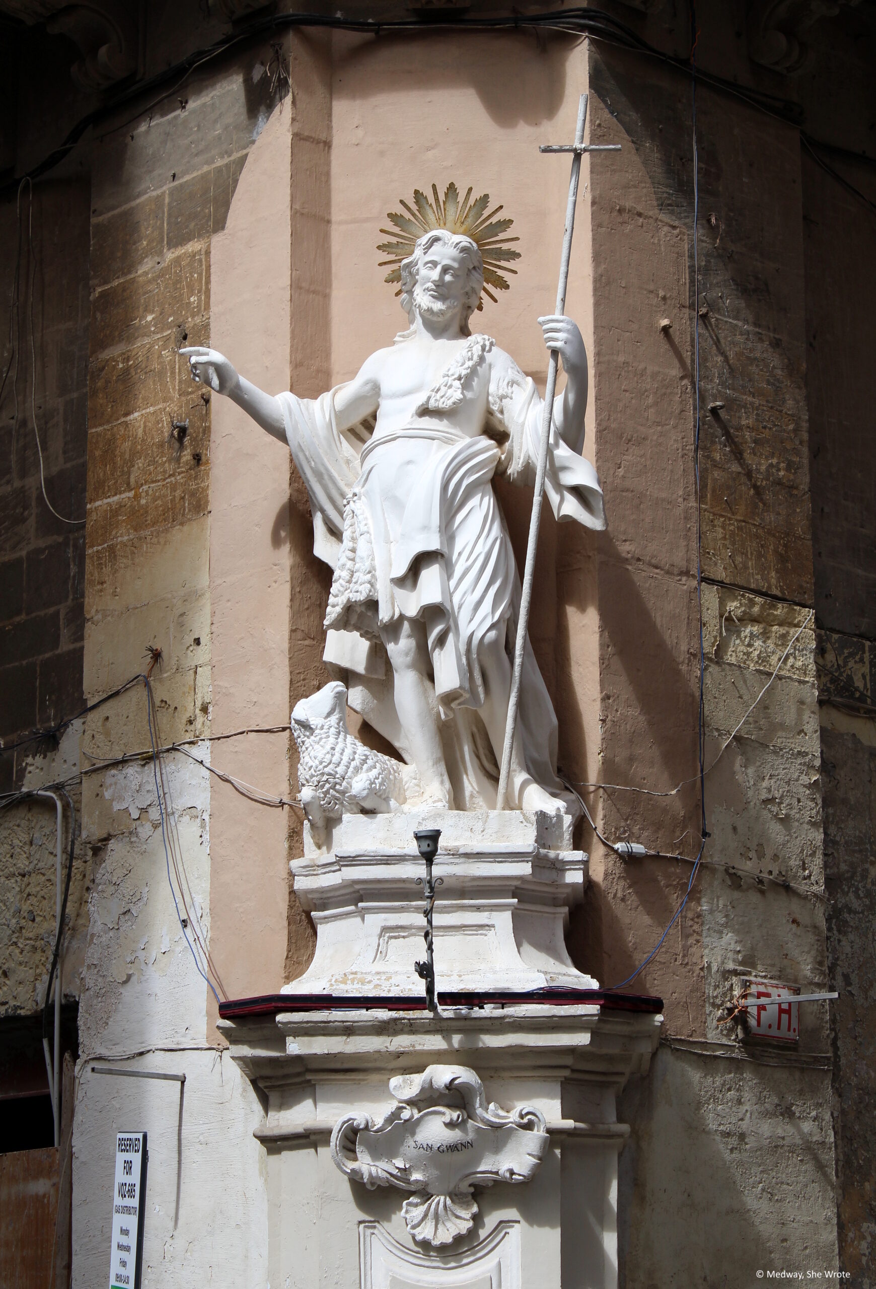 A statue of St John on a street corner in Valletta.