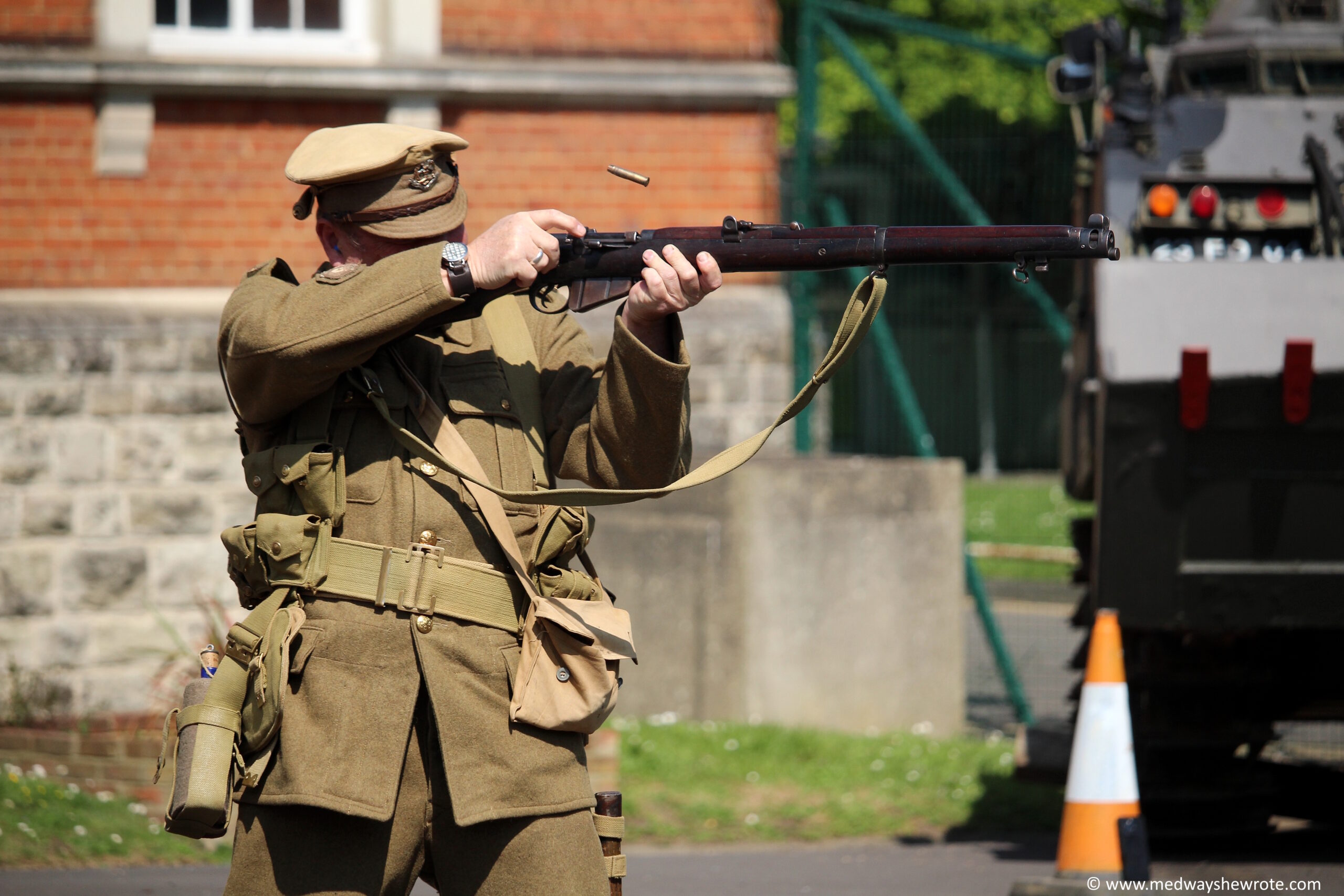 A man dressed as a WW1 British soldier firing a short magazine Lee Enfield bolt action rifle.