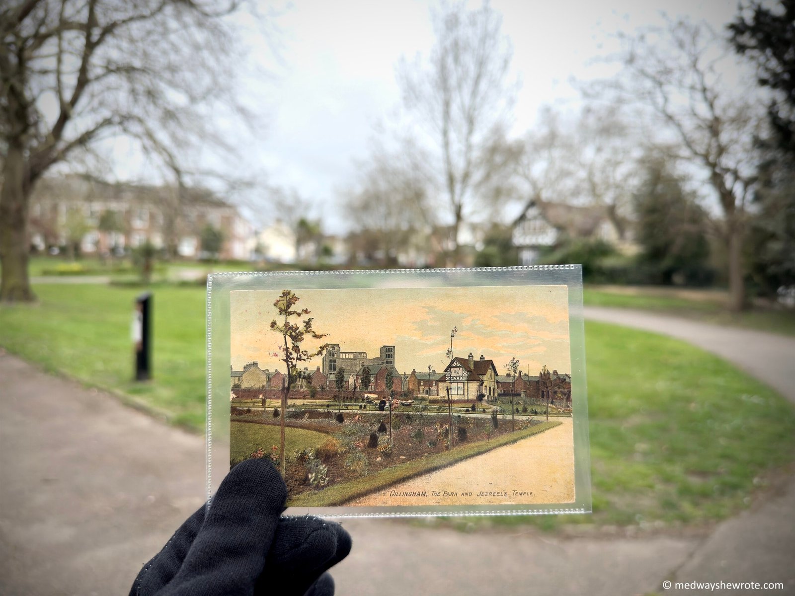 A postcard showing a view of Gillingham Park with Jezreel’s Tower in the background being held up against the same view in the Park today. Jezreel’s Tower is no longer visible in the distance.
