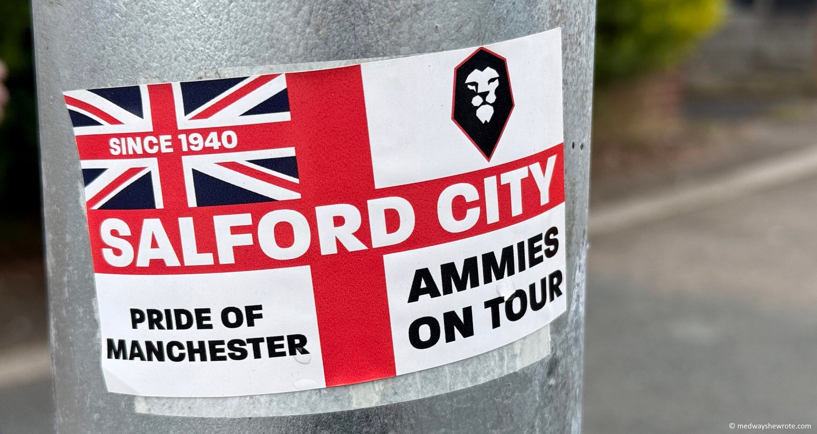 A Salford City FC sticker on a lamp post on Moor Lane.