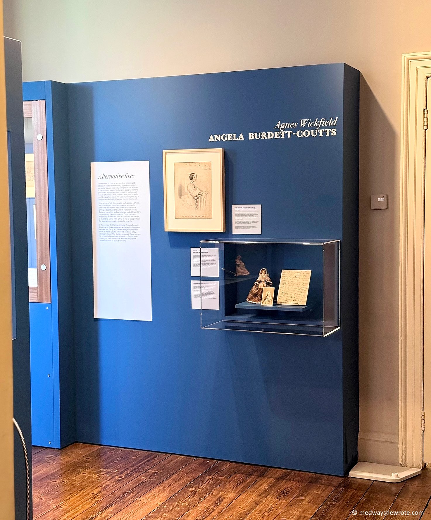 A blue display case dedicated to Angela Burdett-Coutts at the Extra/Ordinary Women exhibition at the Charles Dickens Museum.
